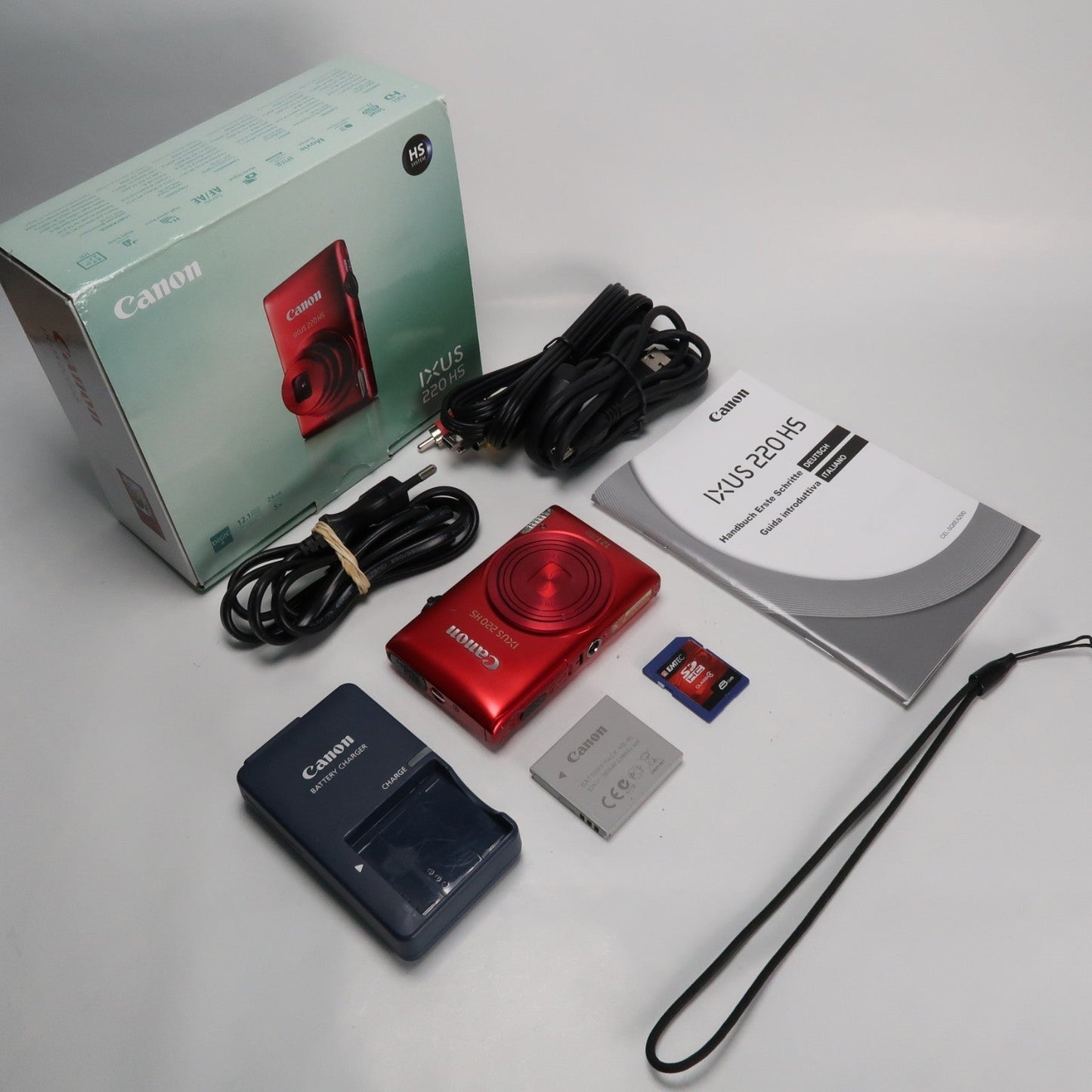 Pre-owned Canon IXUS 220 HS 12.1MP Digital Camera Red – Boxed Set