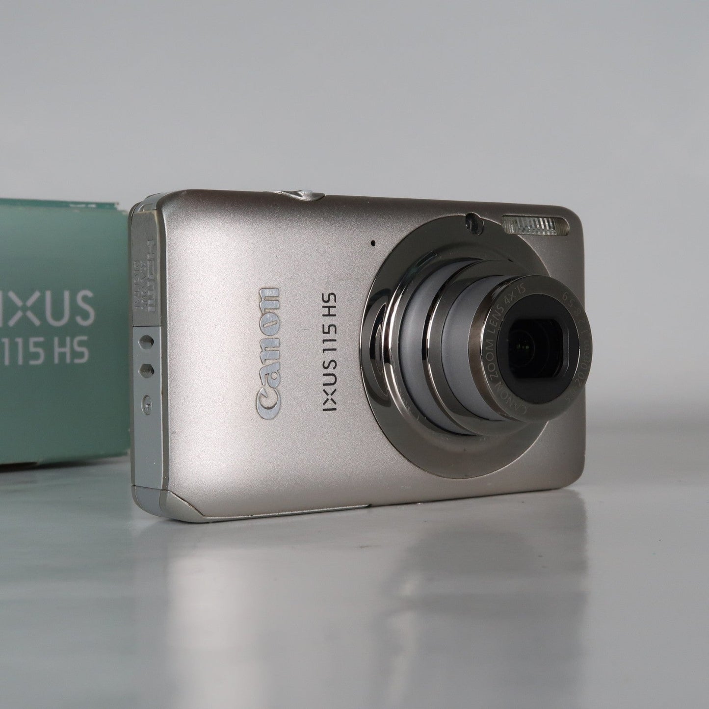 Pre-owned Canon IXUS 115 HS PowerShot ELPH 100 HS 12.1MP 4x Digital Camera Silver – Very Good Condition